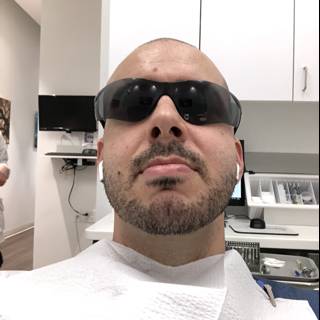 Man with Sunglasses Waiting in Dental Office