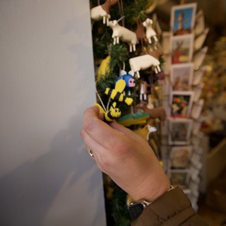 Hand Holding Miniature Bee Figurine in Gift Shop