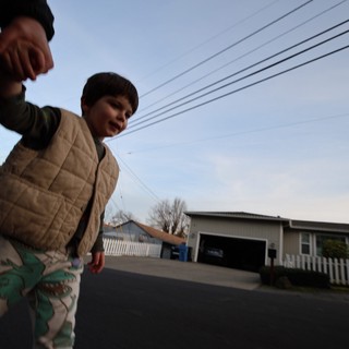 Low Angle Portrait of Child in Suburban Street