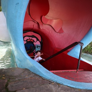 Child Playing Inside Vintage Playground Whale Sculpture