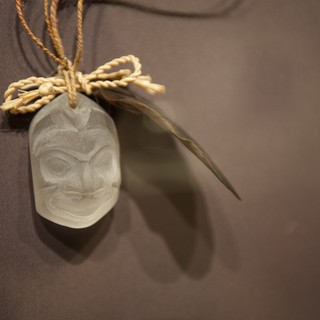 Traditional Carved Pendant with Feather and Rope