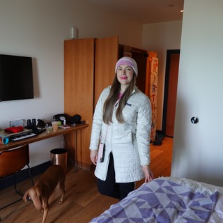 Woman in White Coat Hotel Room Portrait