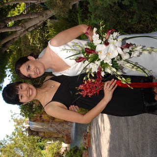 Bride and Bridesmaid Celebrate at Garden Wedding