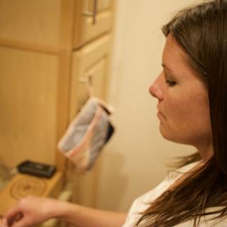 Woman Checking Cabinet in the Kitchen