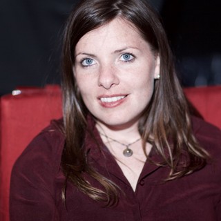 Smiling Woman with Blue Eyes in Red Chair