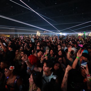 Massive Crowd Surges Under Laser Light Show
