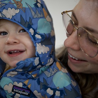Joyful Winter Moment: Parent and Toddler Share a Smile