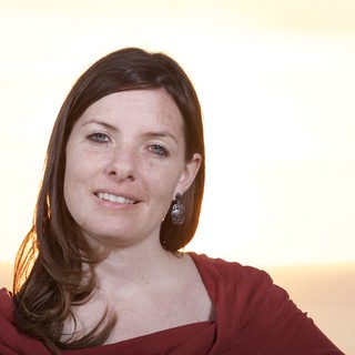 Golden Hour Portrait of a Smiling Woman at Sunset