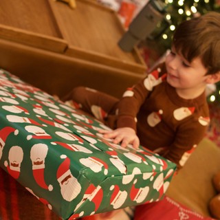 Christmas Morning Joy: Child Opening Festive Present