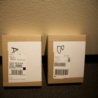 Two Cardboard Boxes with Labels