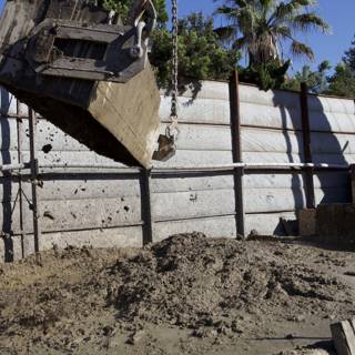 Dump Truck Unloading Soil into a Pile