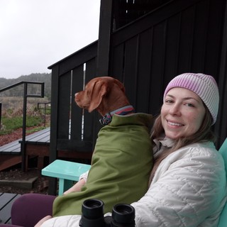 Woman and Dog Relaxing on Coastal Deck