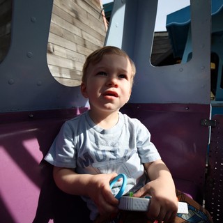Toddler on Playground Equipment at Golden Hour