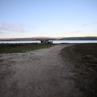 Abandoned Boat at Twilight on Coastal Estuary