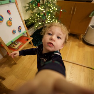 Toddler Reaching Up at Christmas Time
