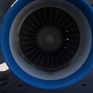 Close-Up View of Aircraft Jet Engine with Blue Cowling