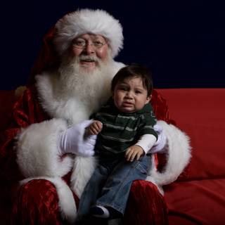 Santa Claus and Child on Festive Couch