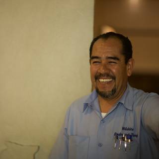 Smiling Man in Blue Shirt