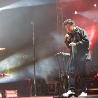 Nick Murphy performing live on stage with his keyboard and microphone
