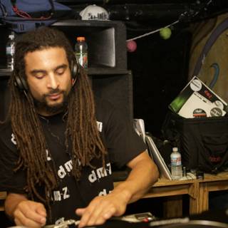 Dreadlocked DJ Grooves to the Beat