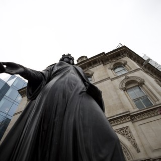 Monument Statue Pointing Forward Against Historic London Architecture
