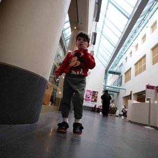 Young Child Exploring Modern Museum Atrium