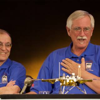 Two Men Discuss Mars Rover Model