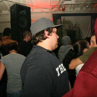 Hat-wearing Musician in a Crowded Urban Nightclub