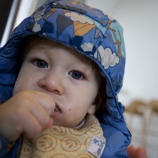 Toddler with Messy Face Eating at Restaurant