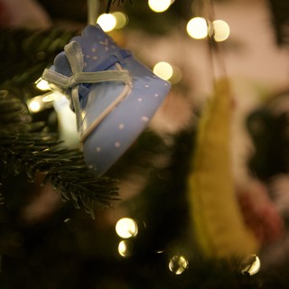 Blue Gift Ornament on Illuminated Christmas Tree