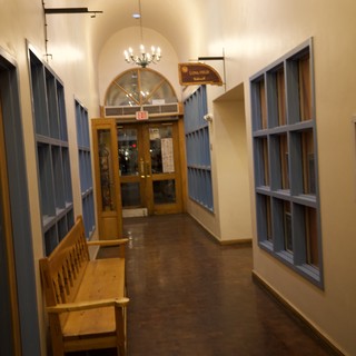 Historic School Hallway with Blue Lockers and Wooden Bench
