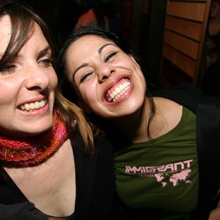Two Friends Laughing Together at a Night Event