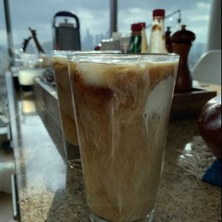 Two glasses of iced coffee on a wooden counter