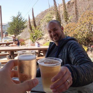 Friends Toasting Beers at Coastal Restaurant