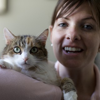 Woman and Tabby Cat Share a Joyful Moment