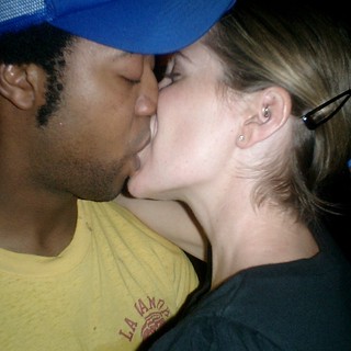 Couple Sharing a Kiss at Nighttime Event