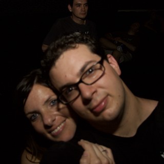 Friends Pose Close Together at Nighttime Event