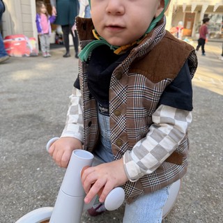 Toddler on Toy Bike at Community Event