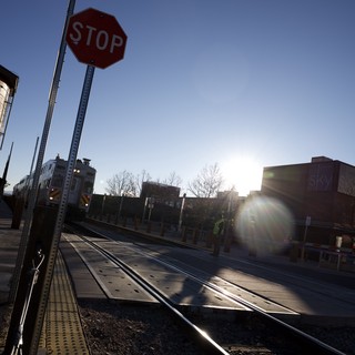 Railroad Crossing at Sunset with Stop Sign
