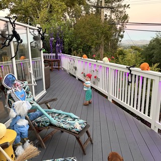 Decorated Deck at Dusk with Child and Dog