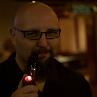 Red-Lighted Pipe in the Hand of a Bearded Man