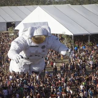 Giant Astronaut Amuses a Sea of People