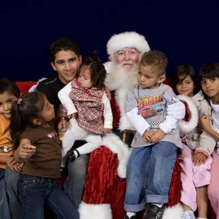 Santa Claus Visits with Excited Children on Christmas Eve