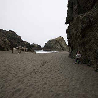 Child Explorer in a Secluded Rocky Cove Beach