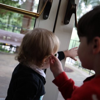 Parent Comforting Young Child by Open Door