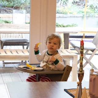 Toddler Enjoying Christmas Eve Breakfast at Home