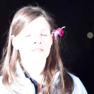 Serene Woman with Pink Flower in Hair