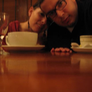 Couple Leans In Close at Cozy Restaurant Table