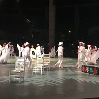 Stage Performers in White Costumes