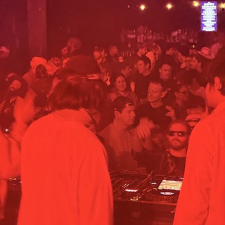 Red-Lit DJ Set at Electronic Music Event